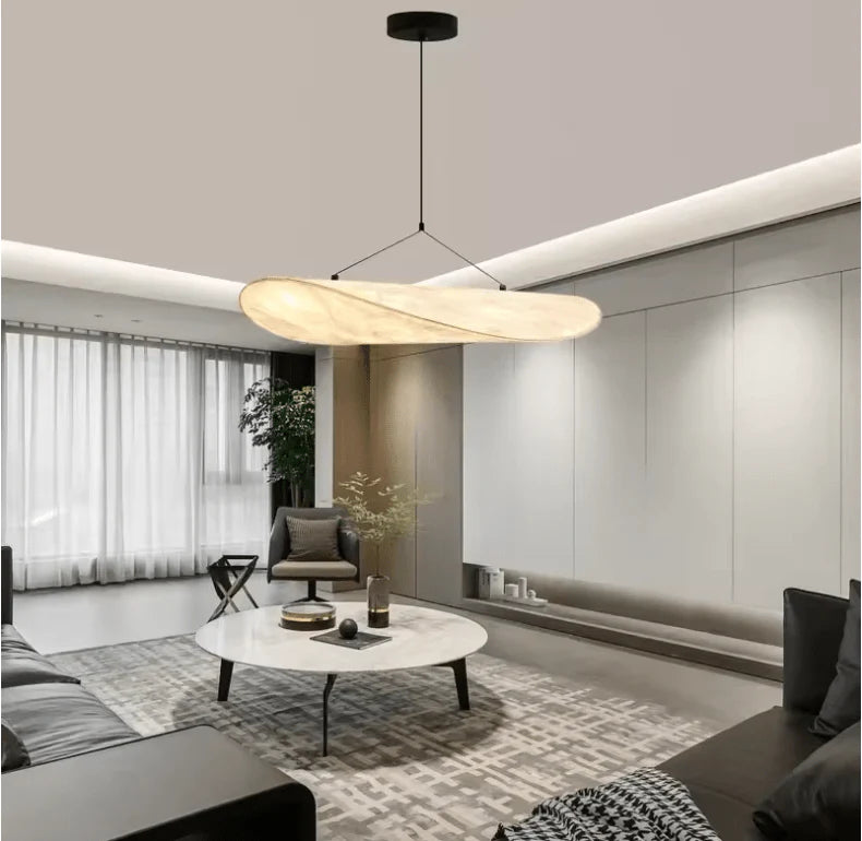 Adara pendant light over a marble coffee table in a modern living room