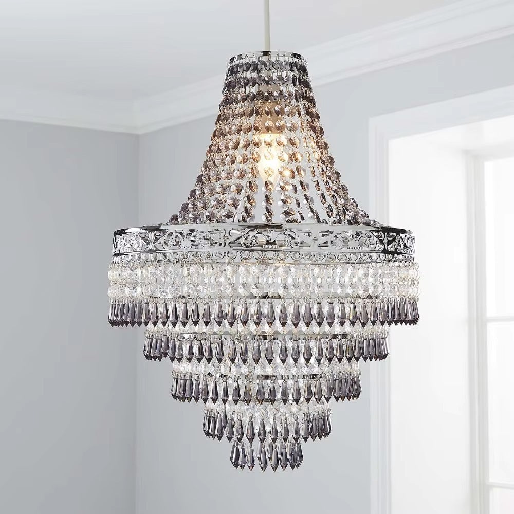 Antique crystal chandelier in chrome, smoked finish, lit in a bright room