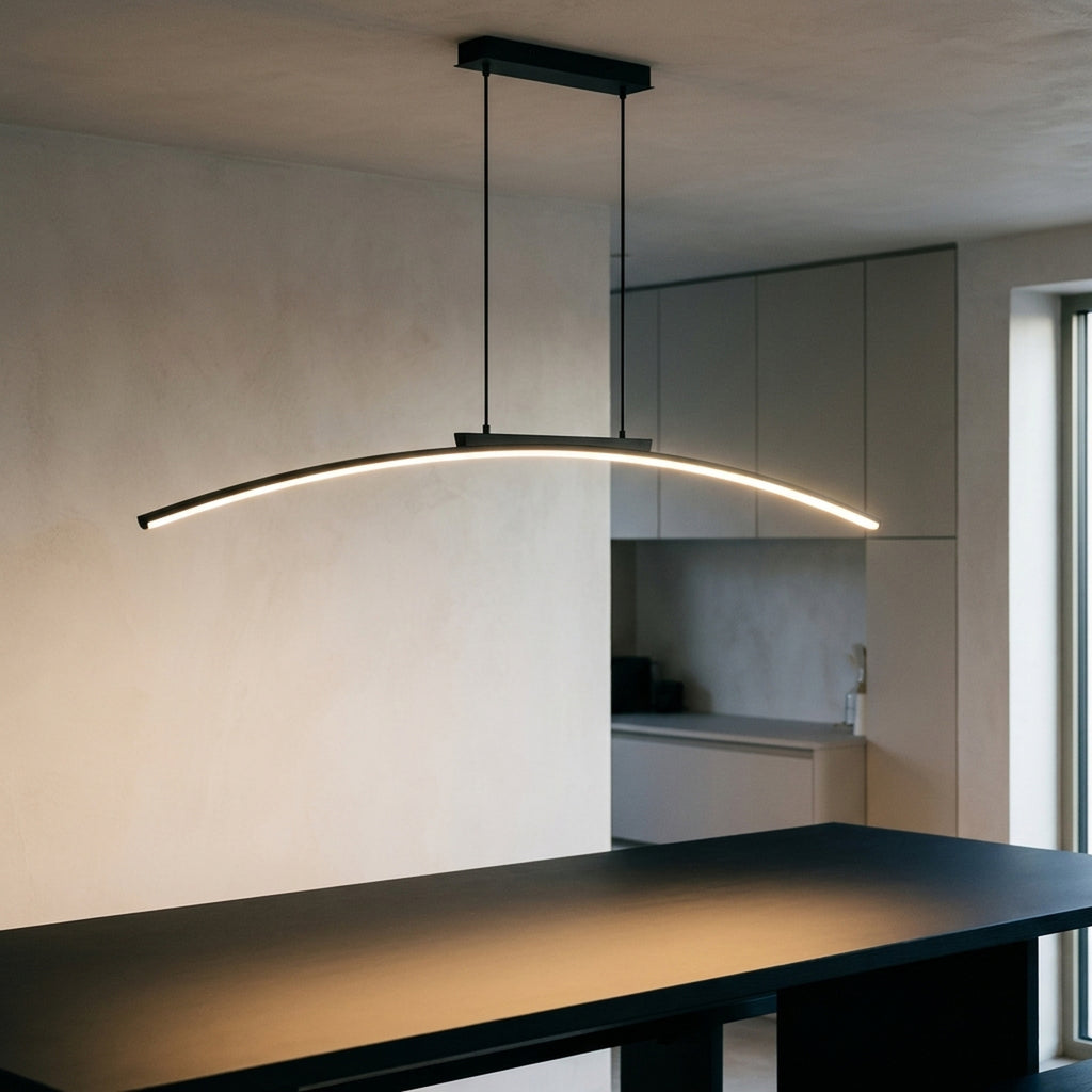 Black arc LED chandelier switched on above a black dining table