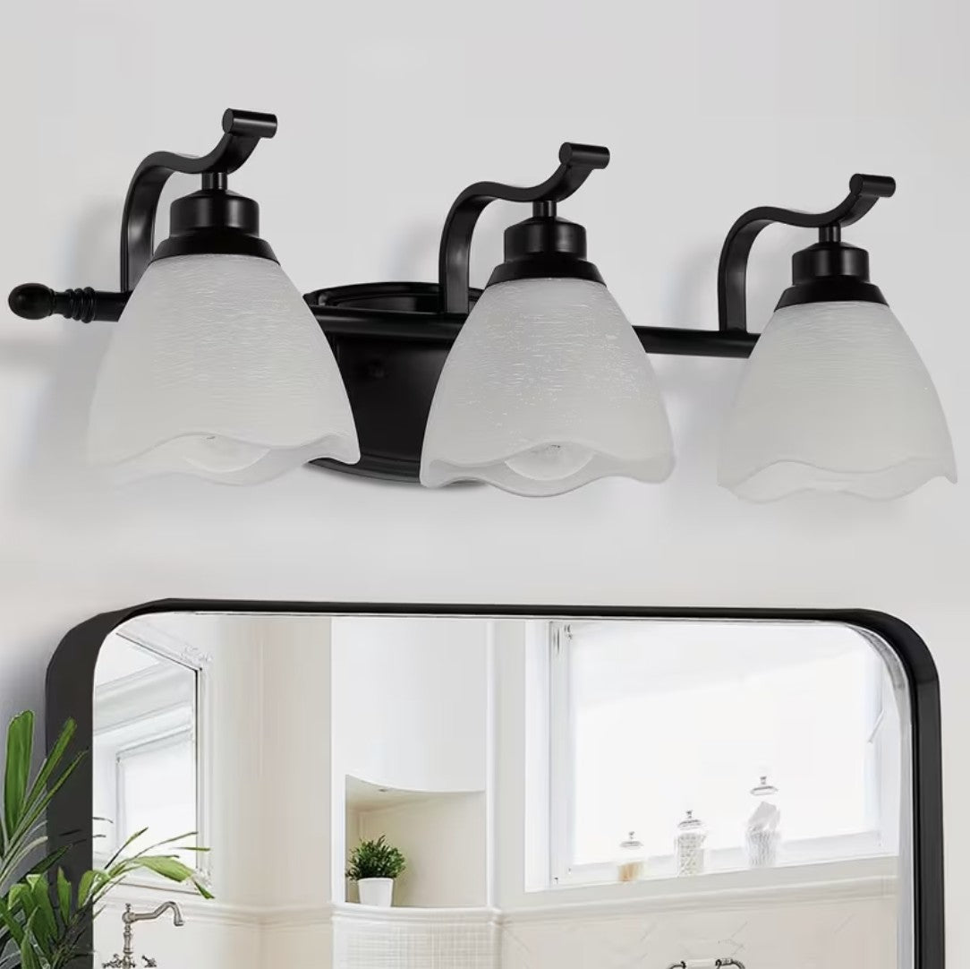 3 light bathroom vanity light in matte black above a mirror