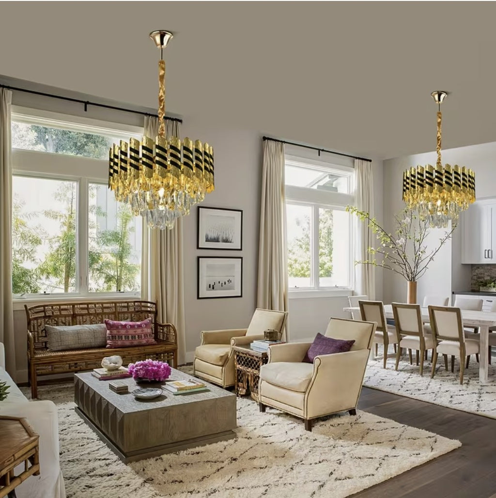 Two black and gold crystal chandeliers in an open plan living room