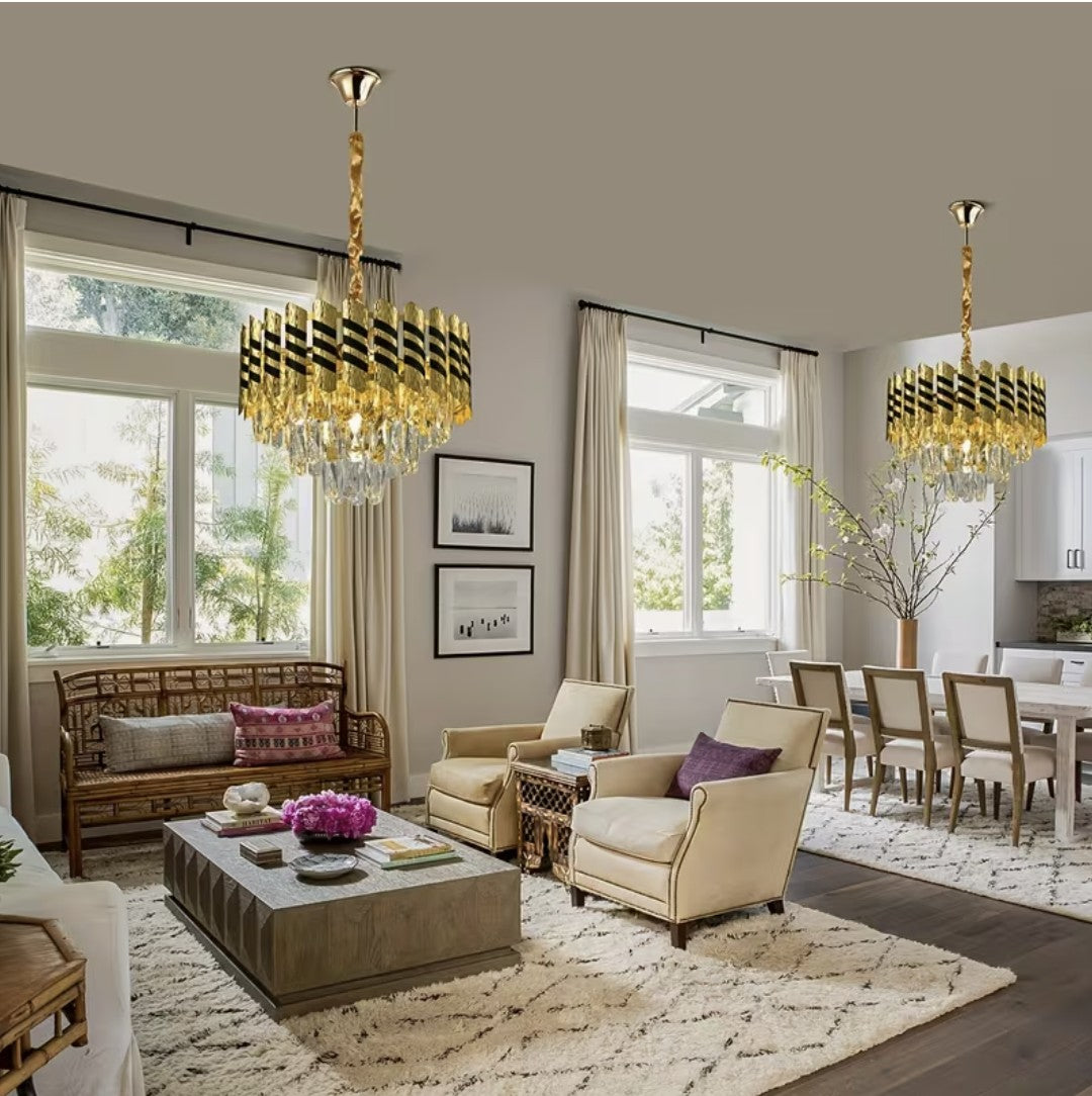 Two black and gold crystal chandeliers in an open plan living room