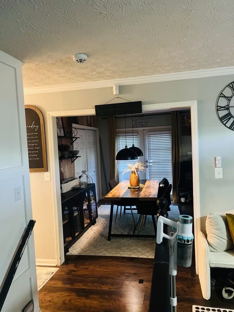 Black and gold dome pendant lights seen from the hallway of a home