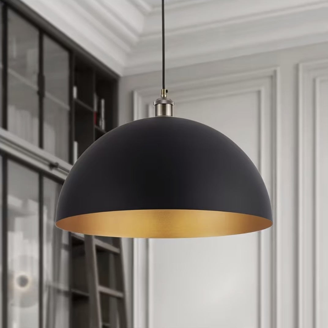 Black and gold dome pendant light hanging in a study