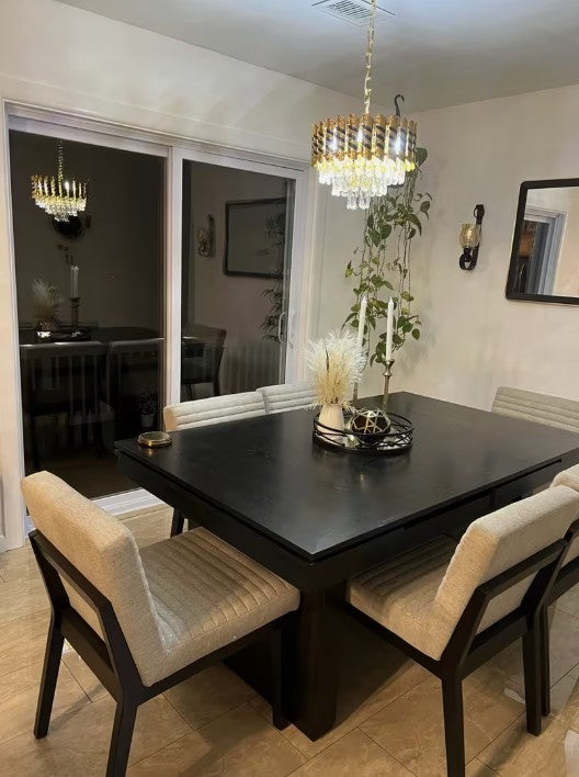 Black crystal chandelier above a dining table in a real home