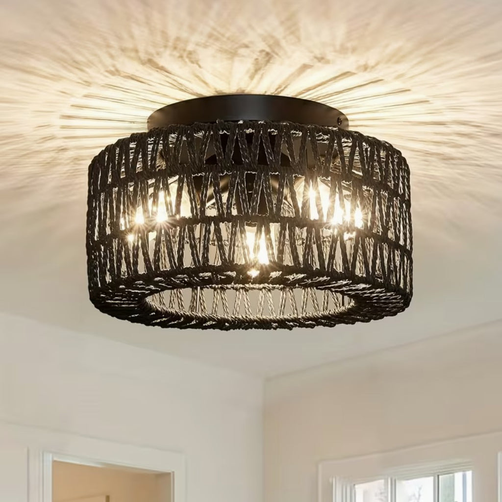 Black boho flush mount ceiling light in woven fiber, lit