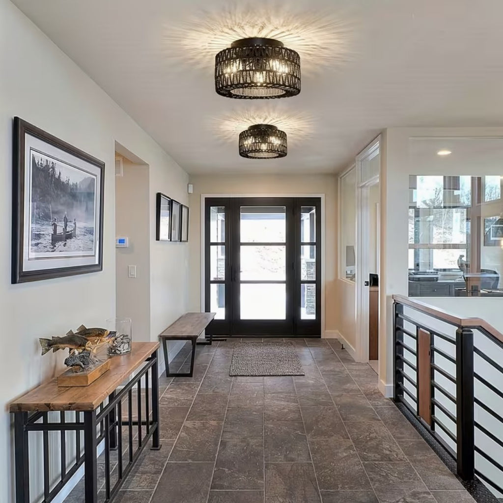 Two black boho flush mount ceiling lights in an entryway hallway