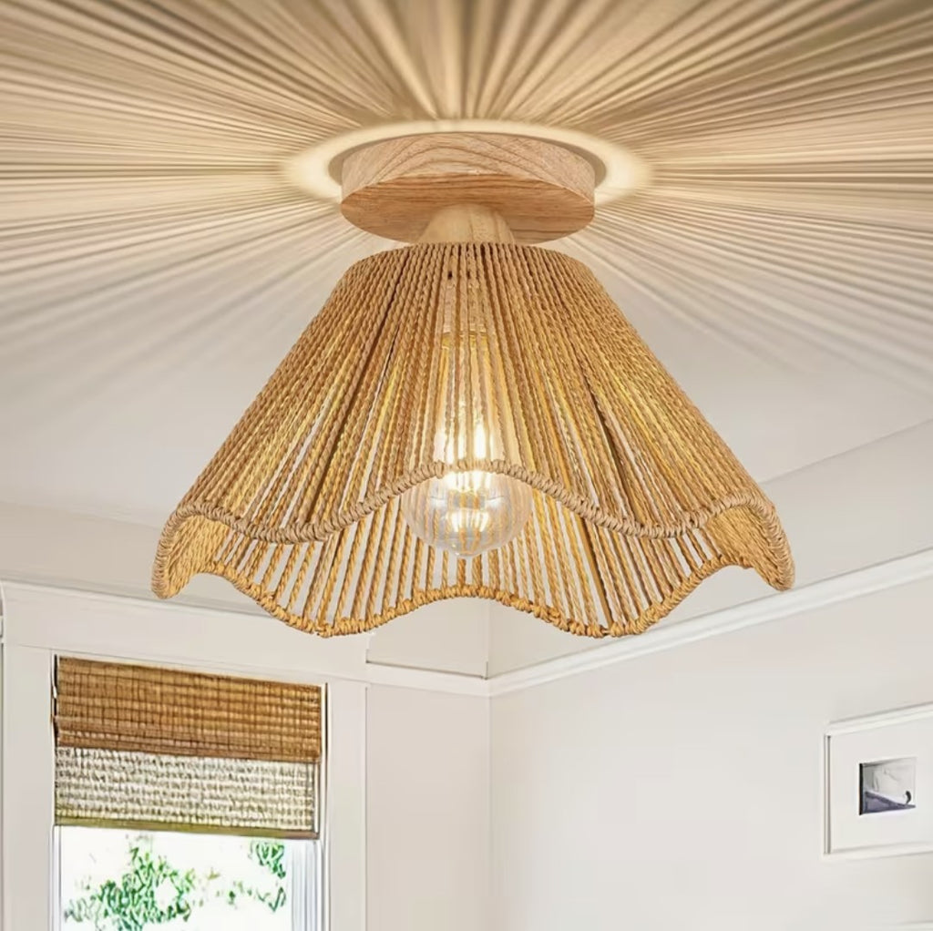 Boho ceiling light fixture in natural woven fiber with scalloped edge, lit