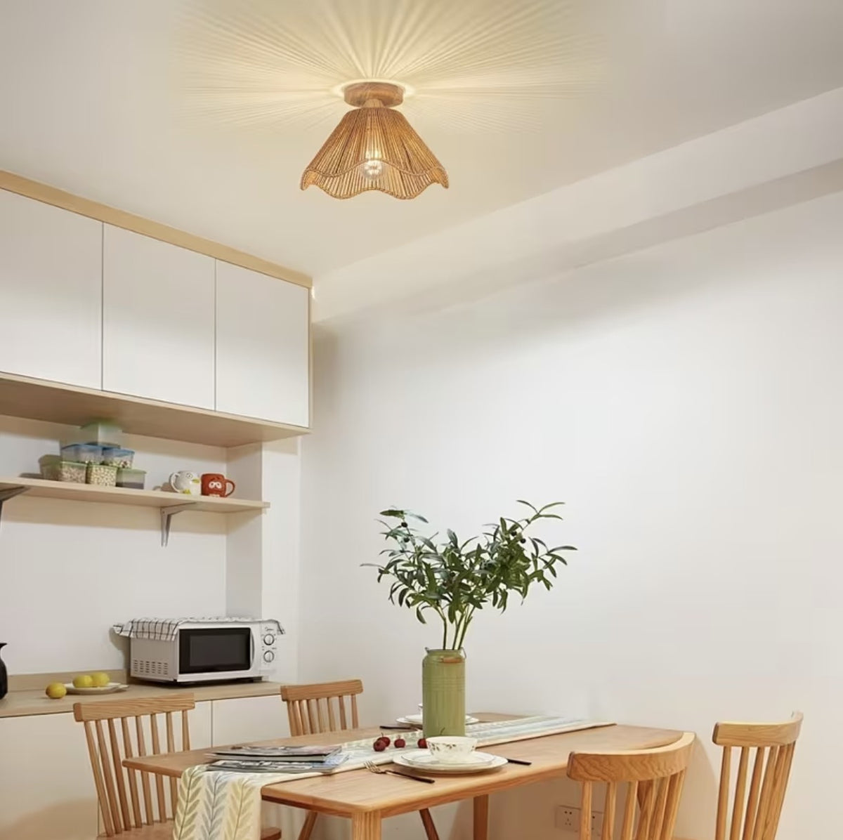 Boho woven ceiling light fixture in a dining room with a wooden table