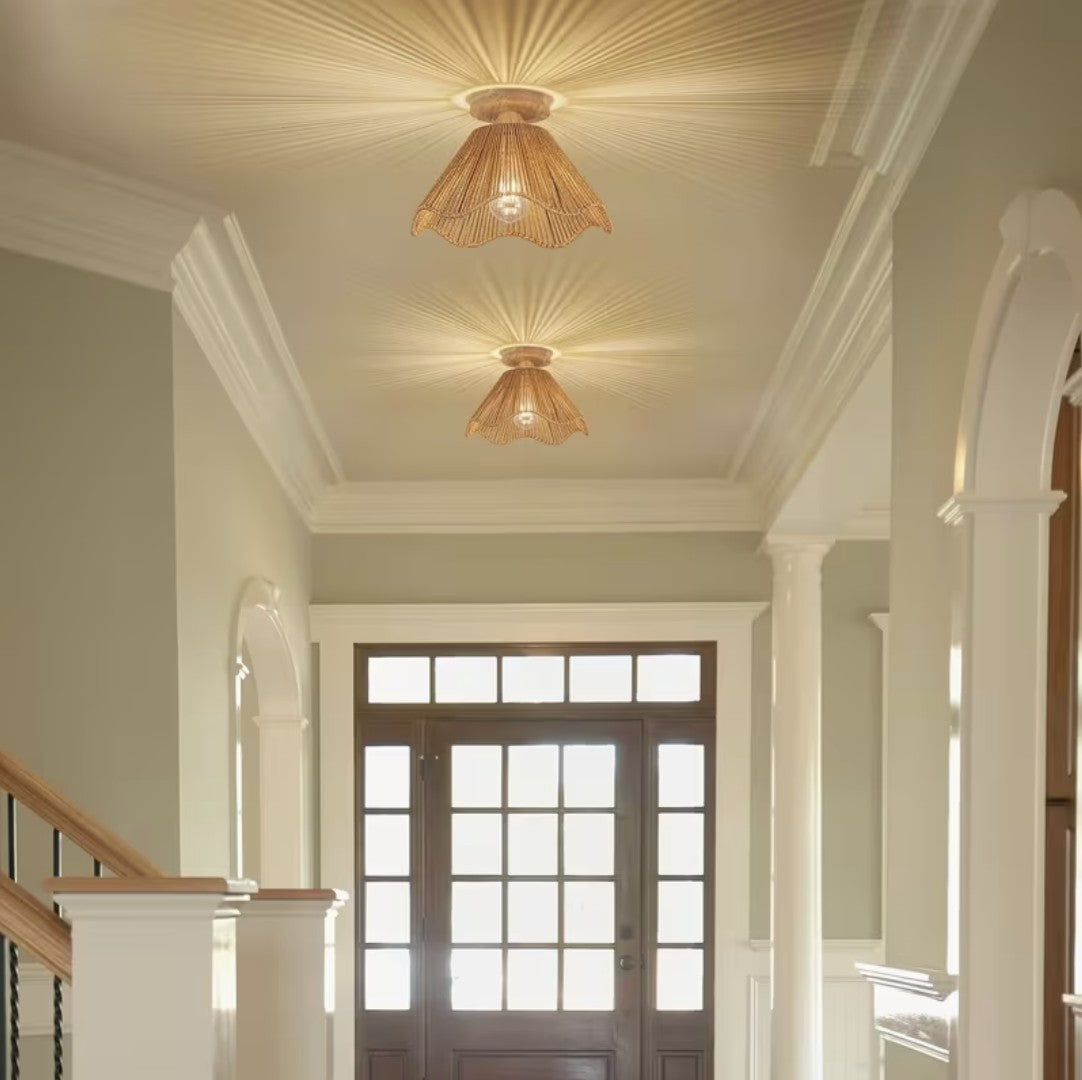 Two boho woven ceiling light fixtures casting a radiating pattern in a hallway