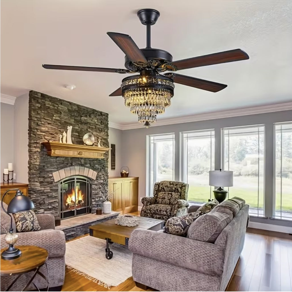 Black crystal chandelier ceiling fan in a living room with a stone fireplace