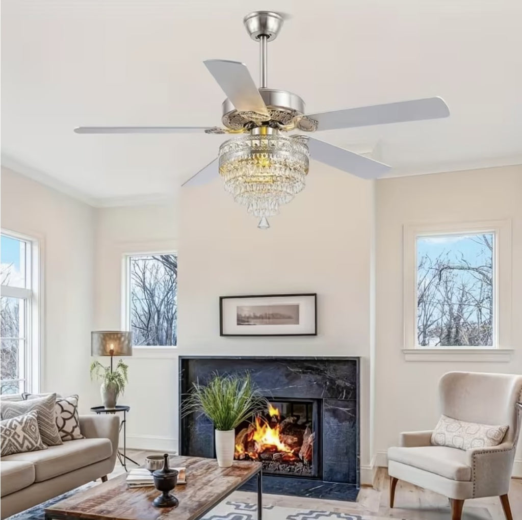 Silver crystal chandelier ceiling fan above a living room fireplace