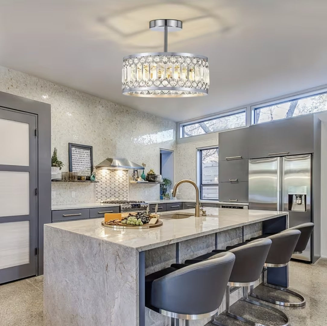 Crystal flush mount ceiling light above a marble kitchen island