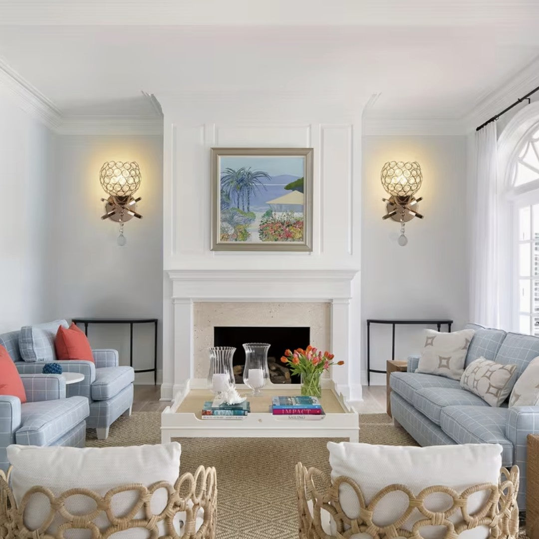 Crystal globe wall sconces framing a fireplace in a living room