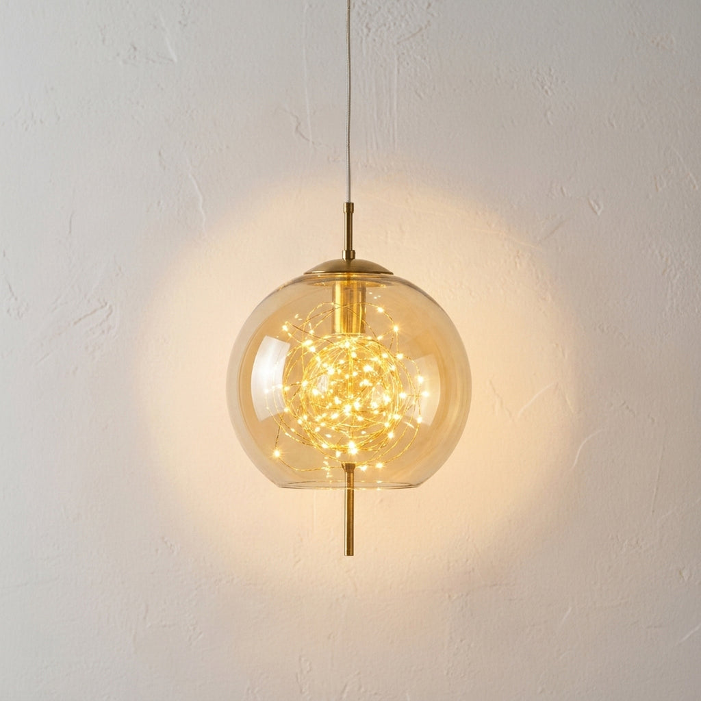 Amber glass globe pendant light lit by a cluster of tiny warm LED filaments