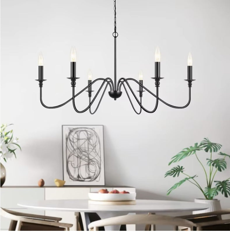 Black farmhouse candle chandelier above a round dining table