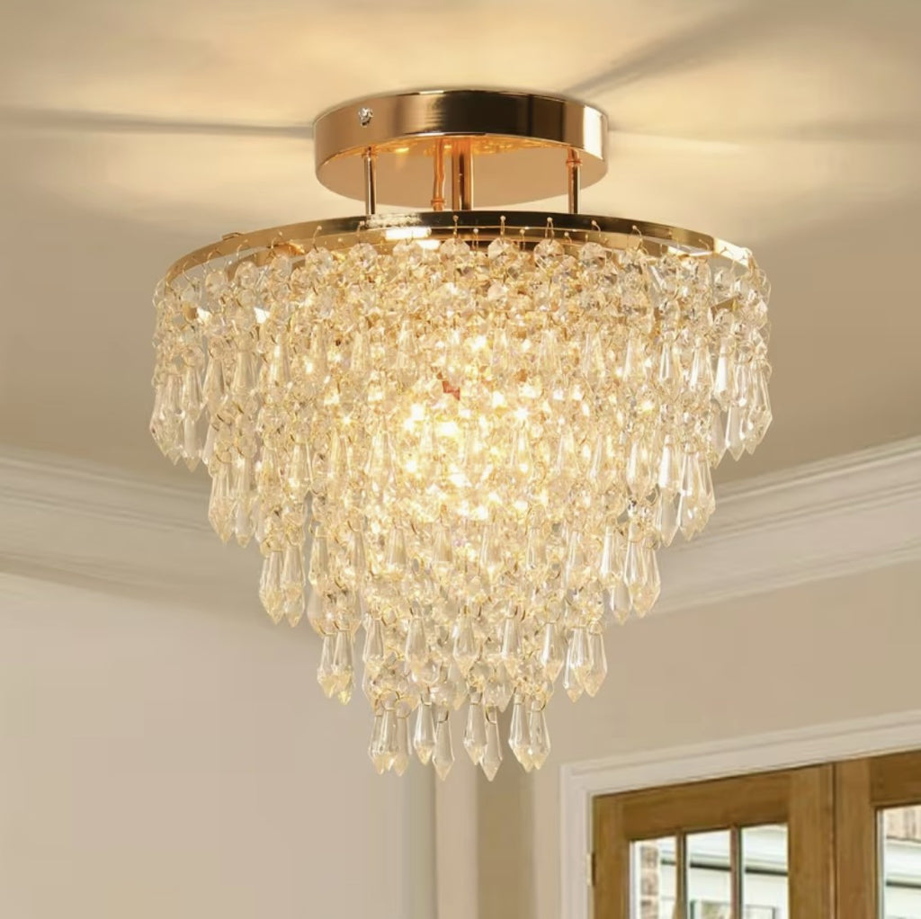 Gold crystal chandelier ceiling light, flush mount, lit above a hallway