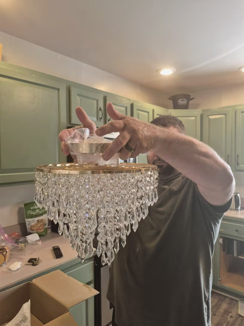 Gold crystal chandelier ceiling light size compared to a person
