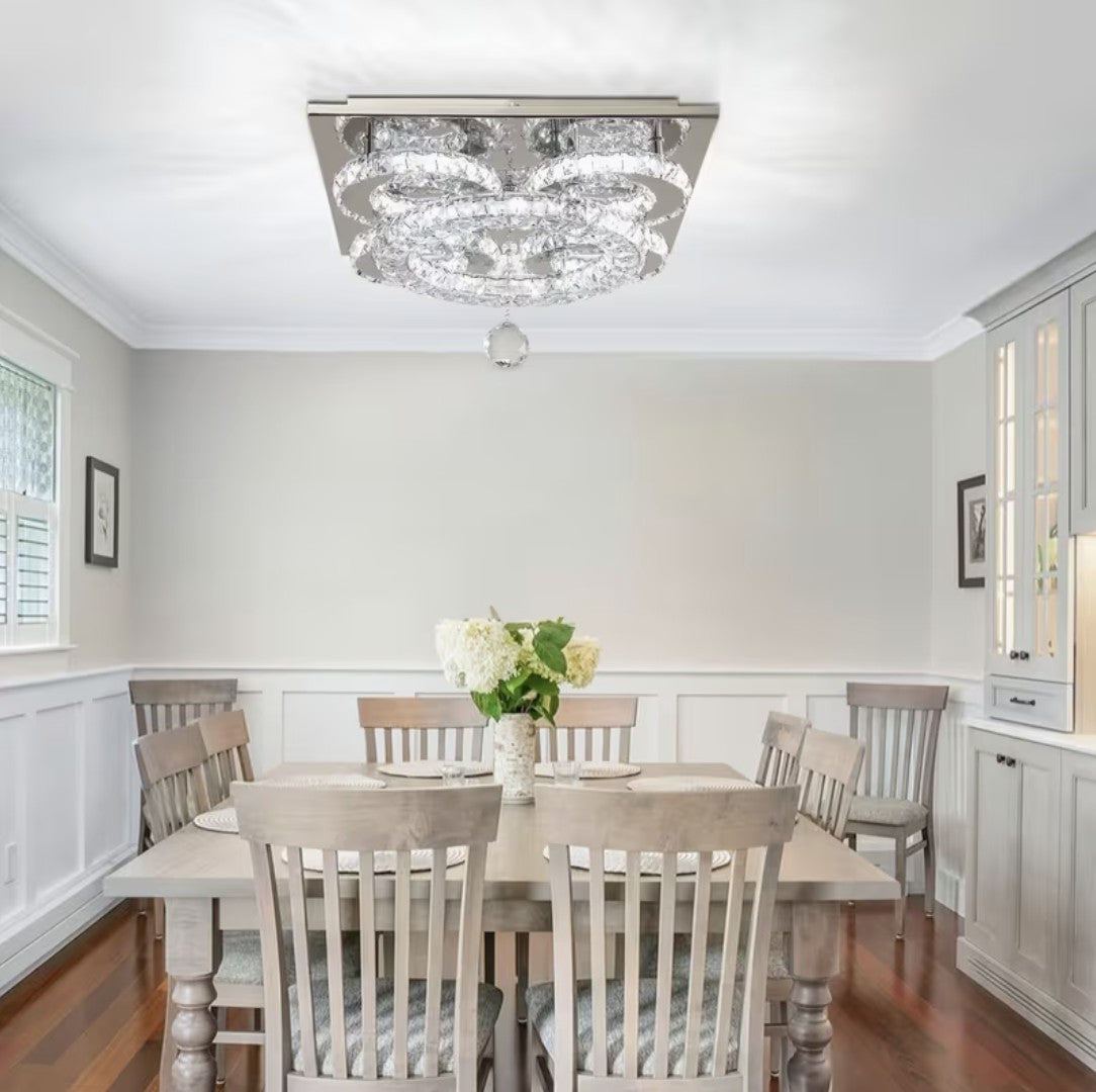 Flush mount crystal chandelier above a dining table