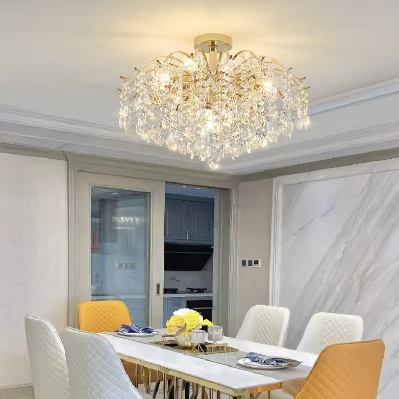 Gold crystal flush mount ceiling light above a dining table