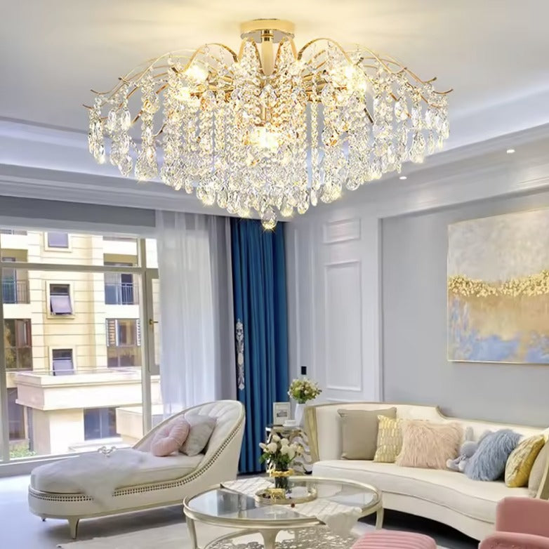 Gold crystal flush mount ceiling light in a living room with blue curtains