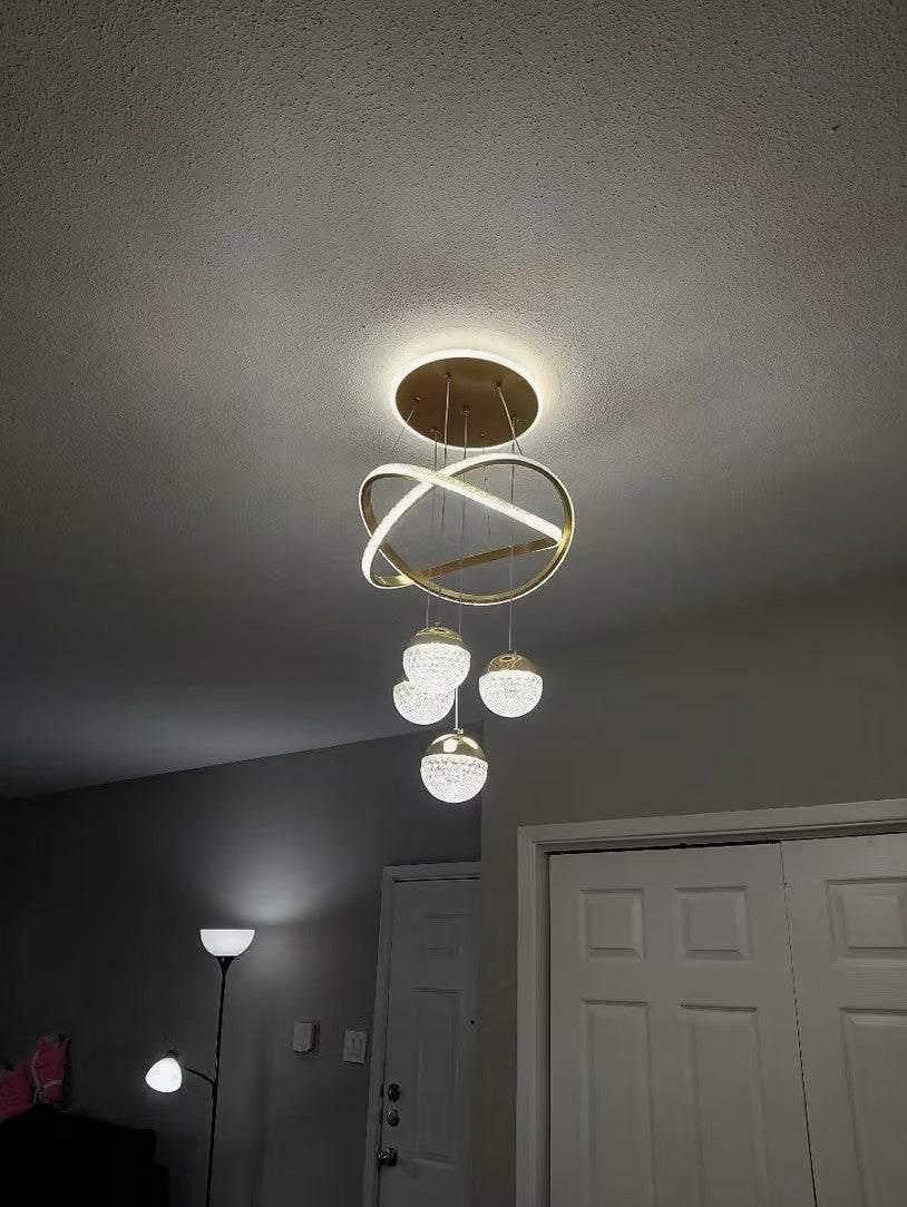 Customer photo, gold globe chandelier seen from below in an entryway