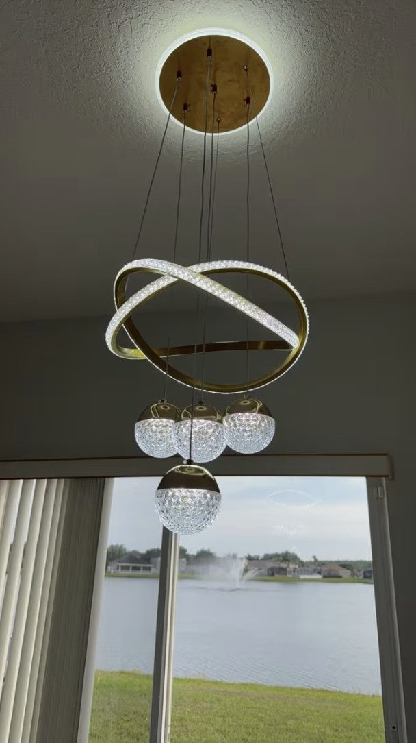 Customer photo, gold globe chandelier switched on beside a window