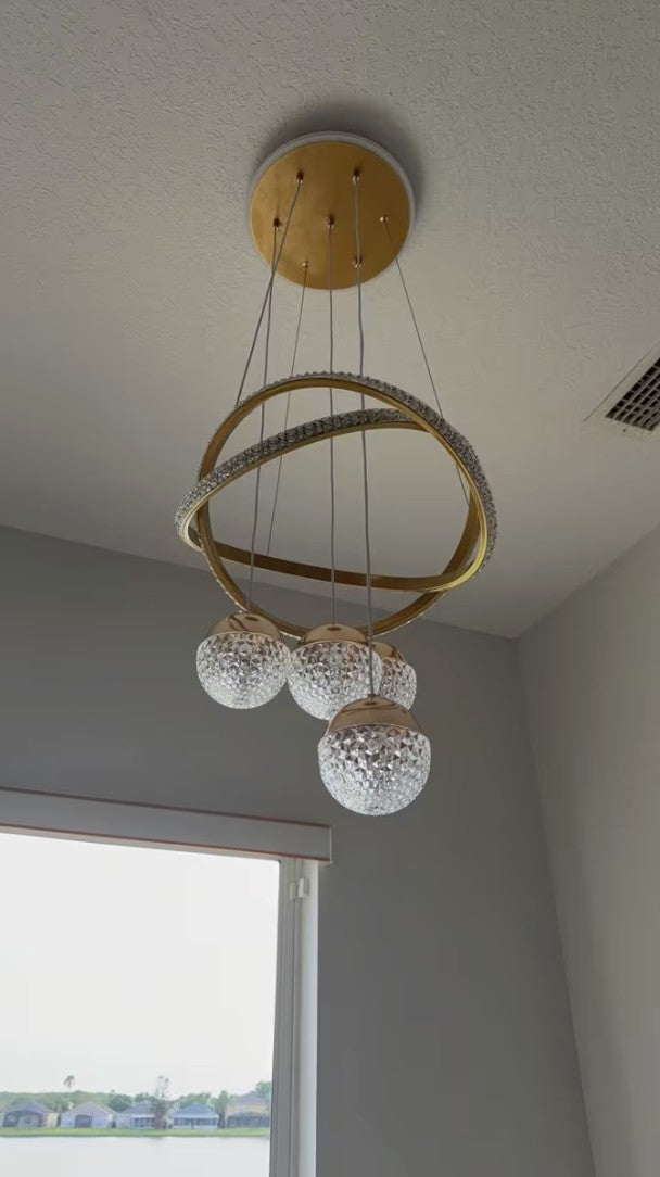 Customer photo, gold globe chandelier beside a large window