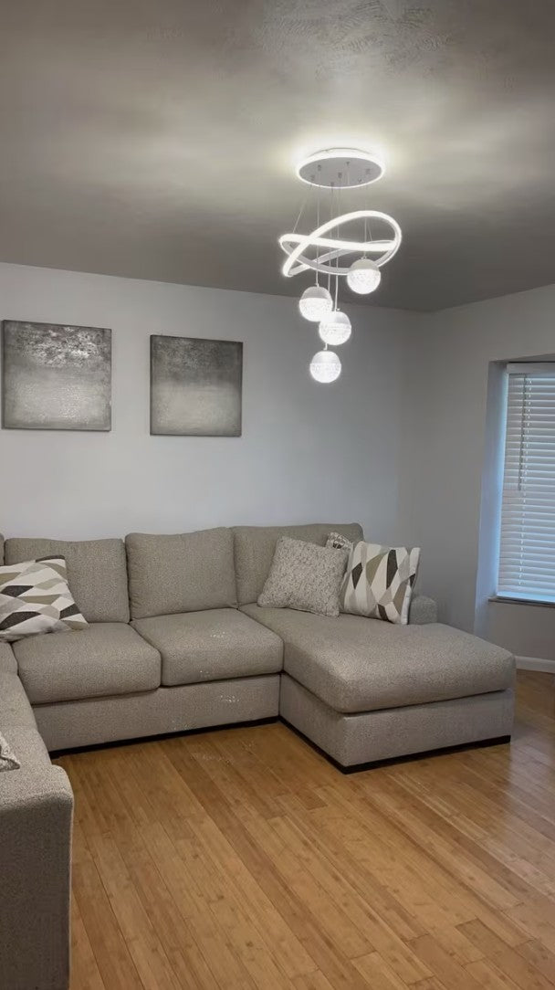 Customer photo, white globe chandelier above a living room sofa