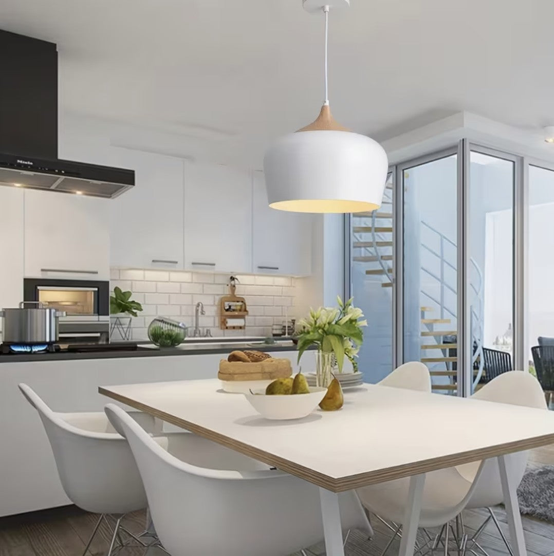 White kitchen island pendant light above a dining table in a modern kitchen