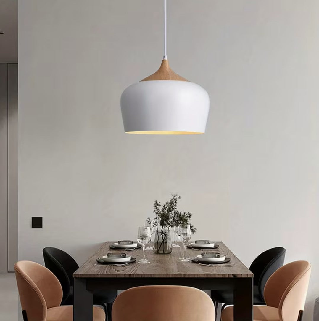Kitchen island pendant light in white above a dining table