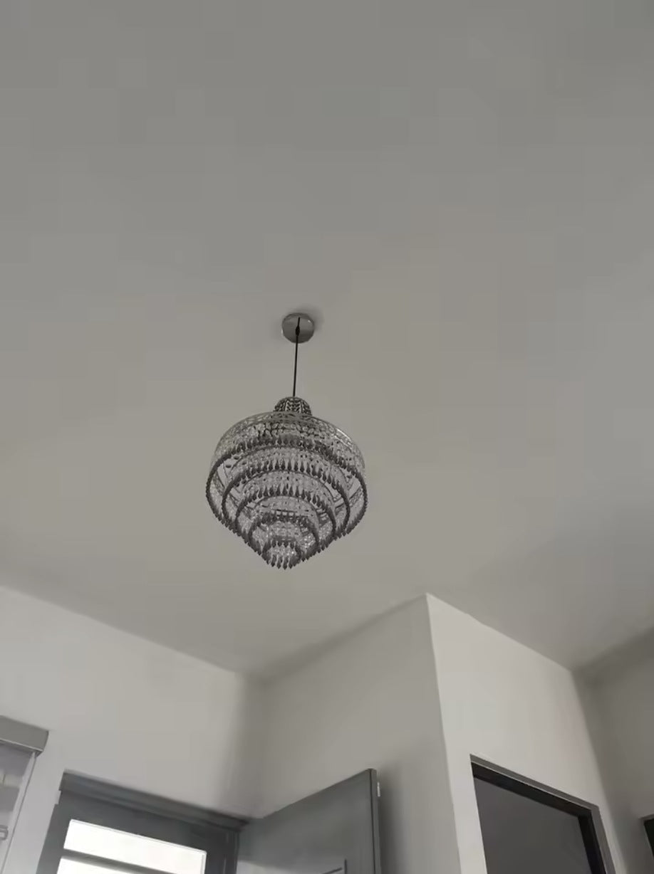 Large empire crystal chandelier seen in a bright room with a high ceiling