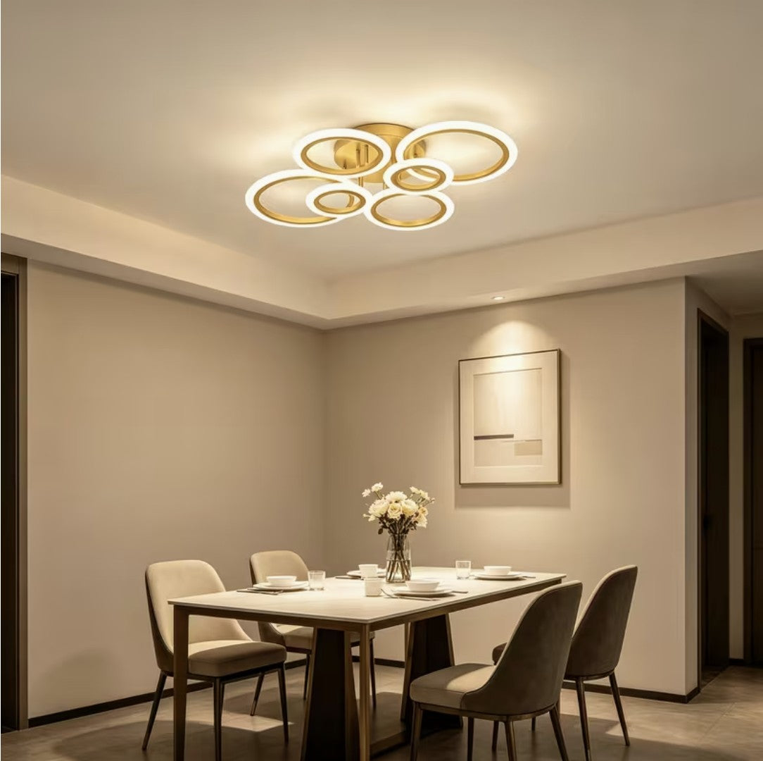 Gold LED ring ceiling light above a dining table