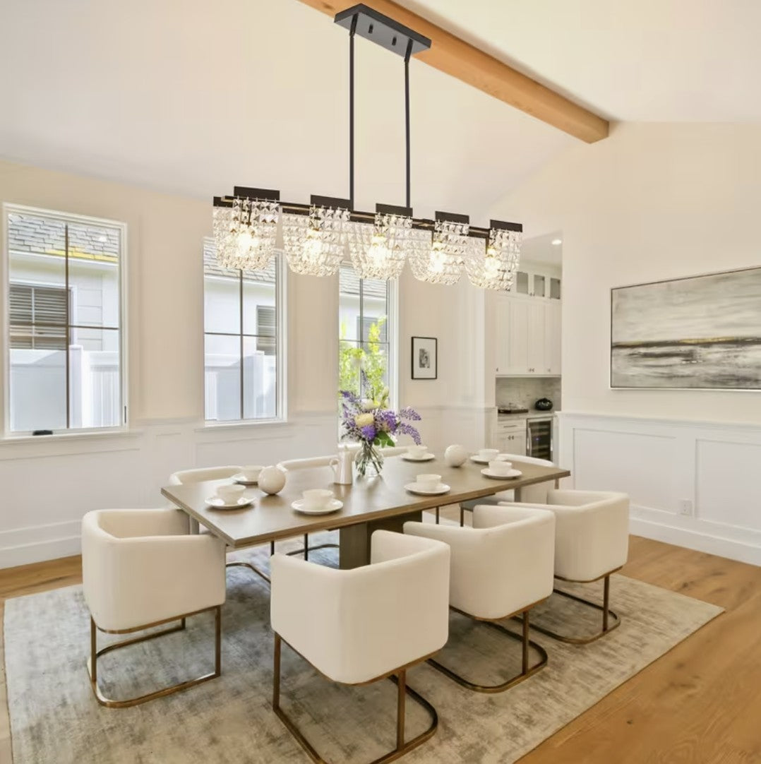 Modern linear chandelier above a dining room table, black finish