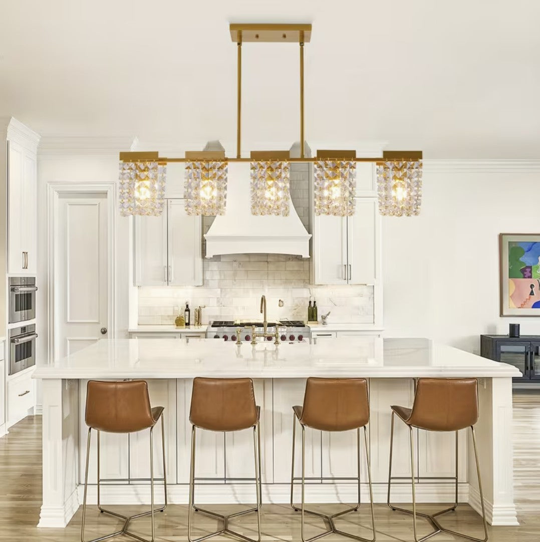 Gold linear chandelier above a kitchen island