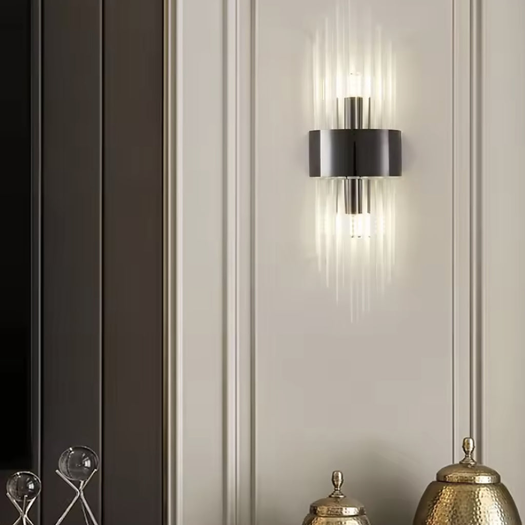Black linear glass rod wall sconce switched on beside a panelled wall