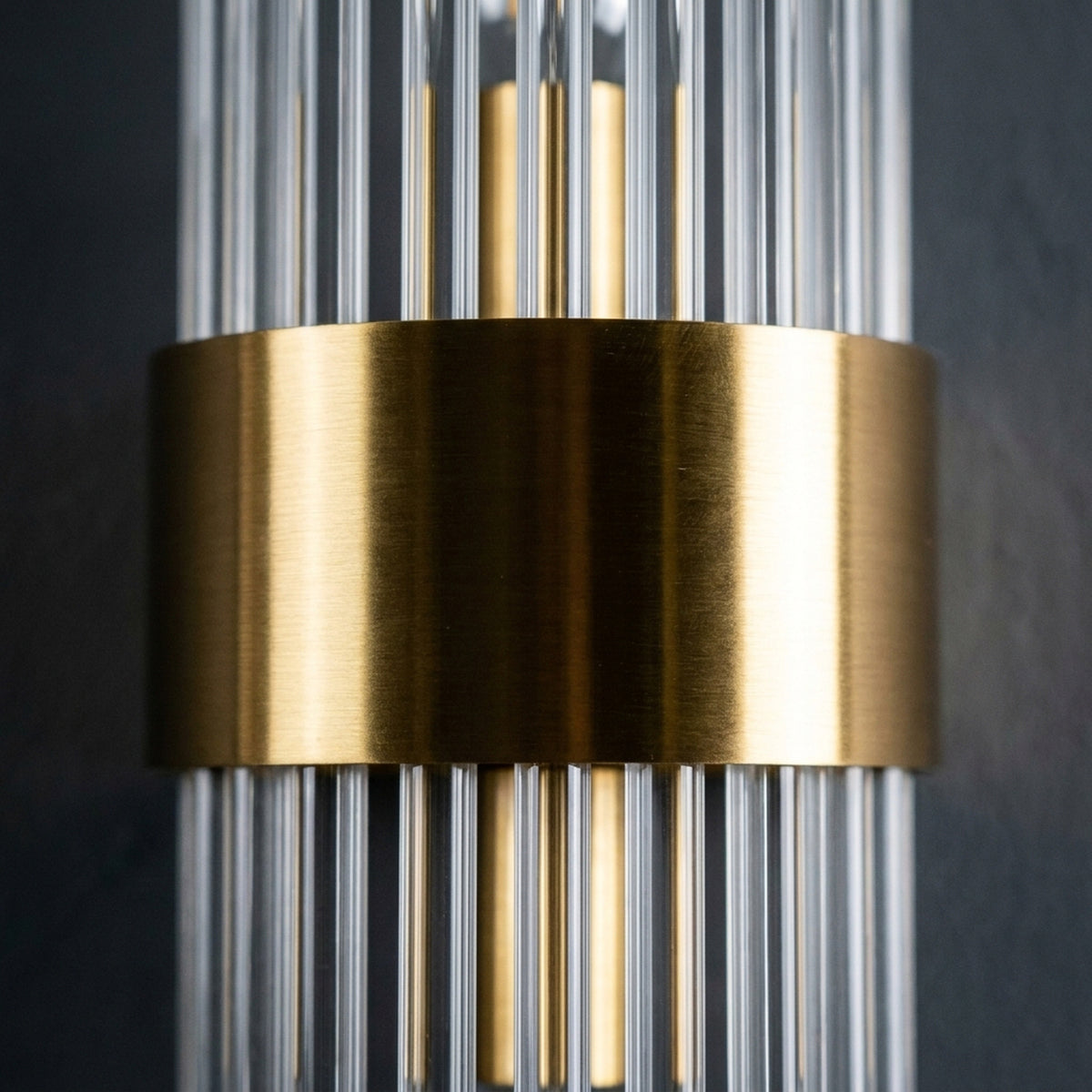 Macro on the single unbroken brushed gold band wrapping the glass rods Image