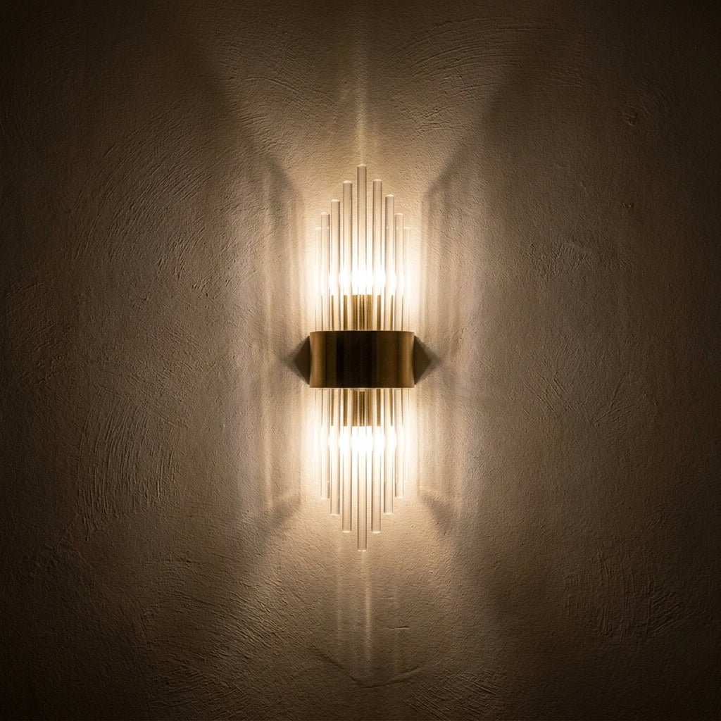 The sconce at night throwing two cones of light up and down the wall