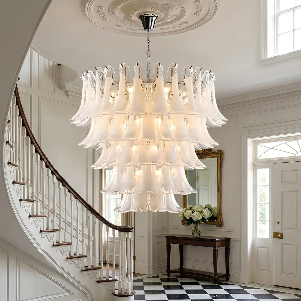 Luxury Murano glass chandelier lit above a staircase in an entrance hall Image