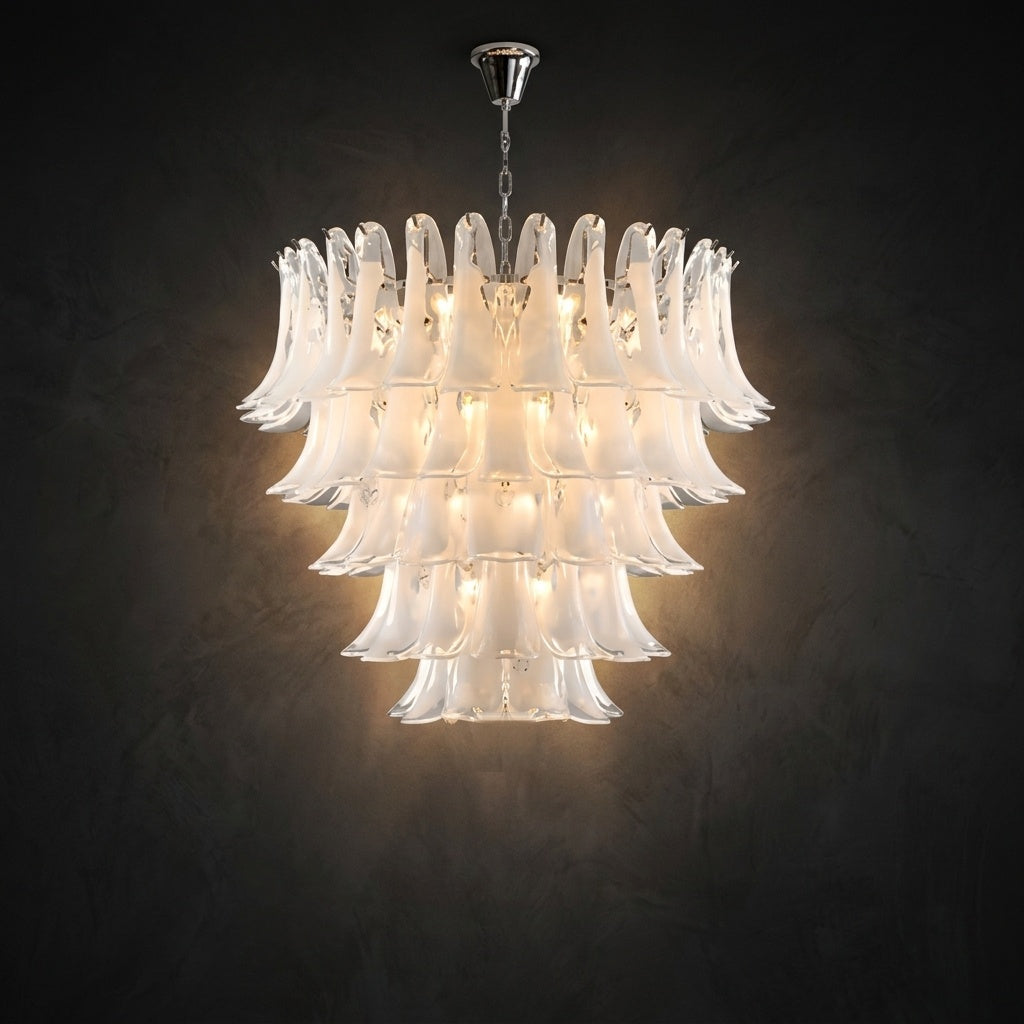 Luxury Murano glass chandelier lit, five tiers of white opaline petals against a dark wall Image