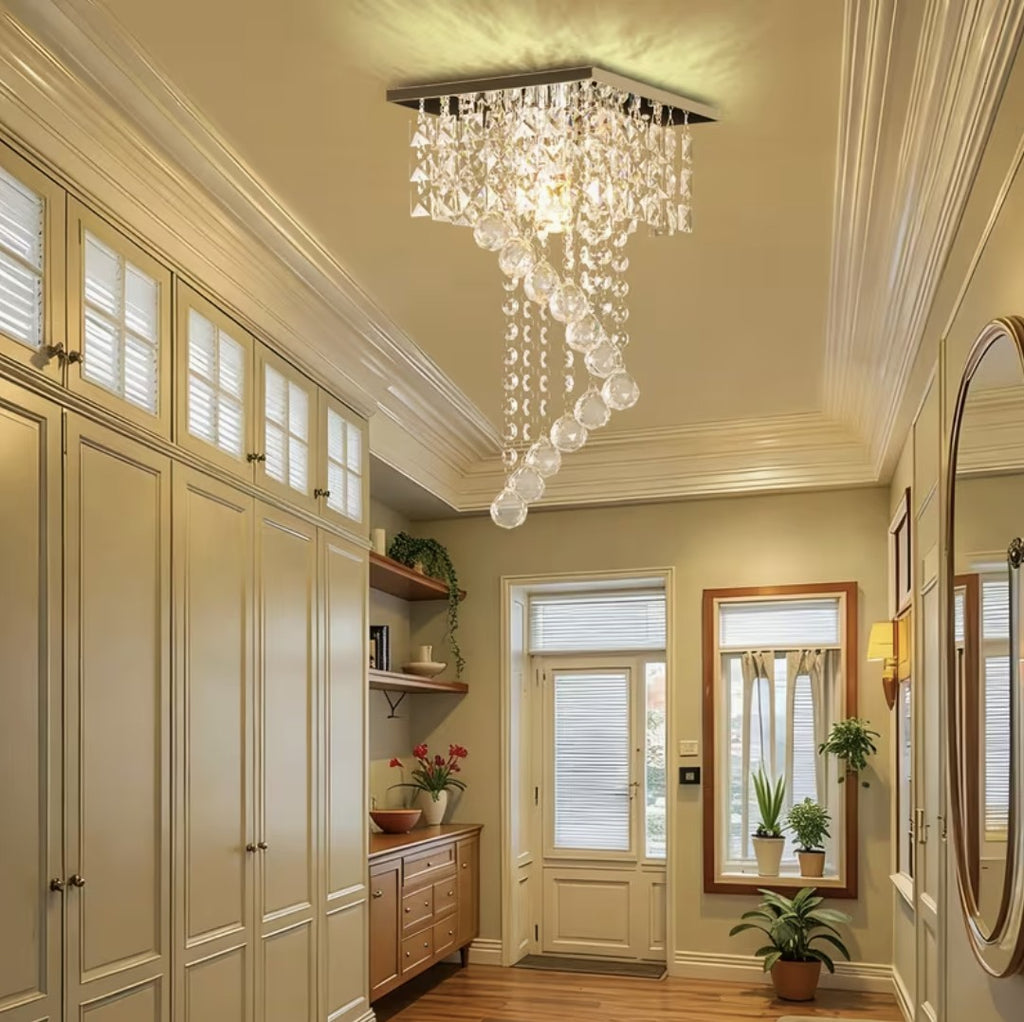 Mini crystal chandelier lighting a warm entryway