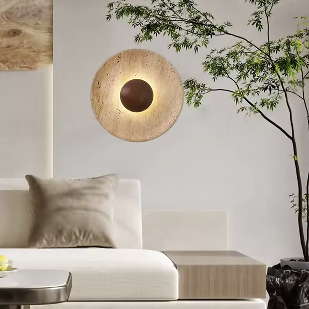 Travertine wall sconce beside a sofa in a bright living room