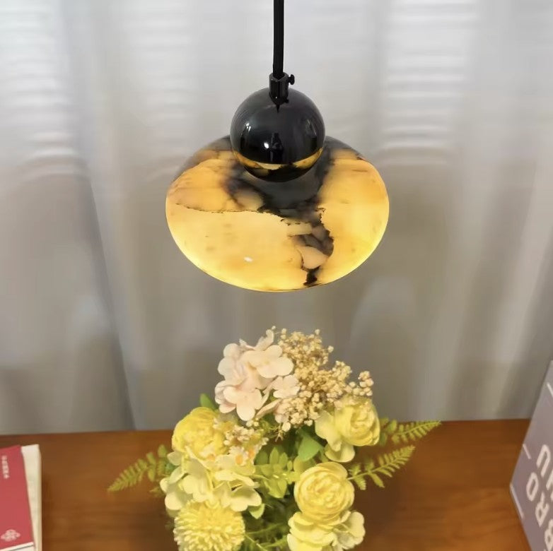 Marble mini pendant light switched on, violet veining showing