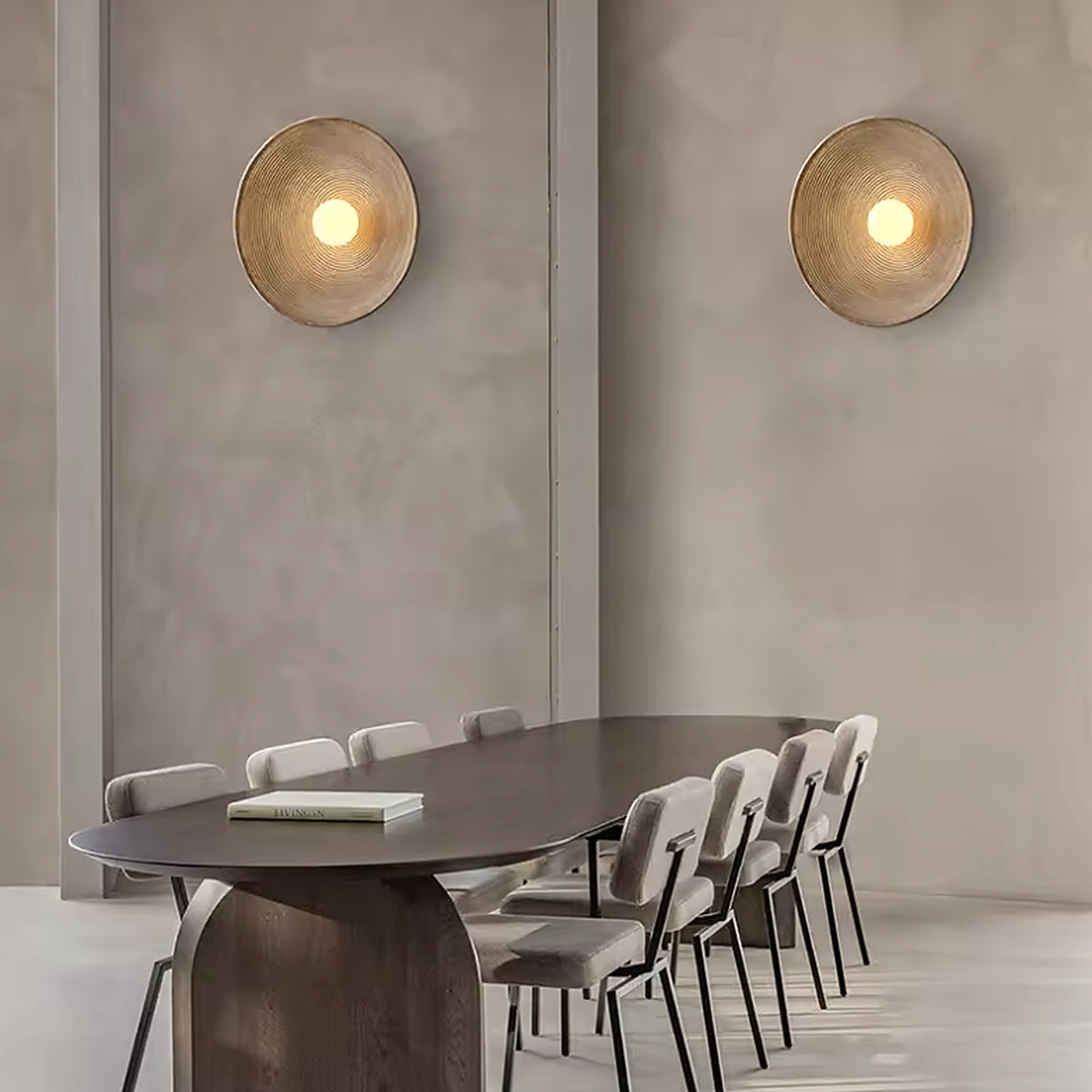 A pair of nordic round wall sconces beside a dining table
