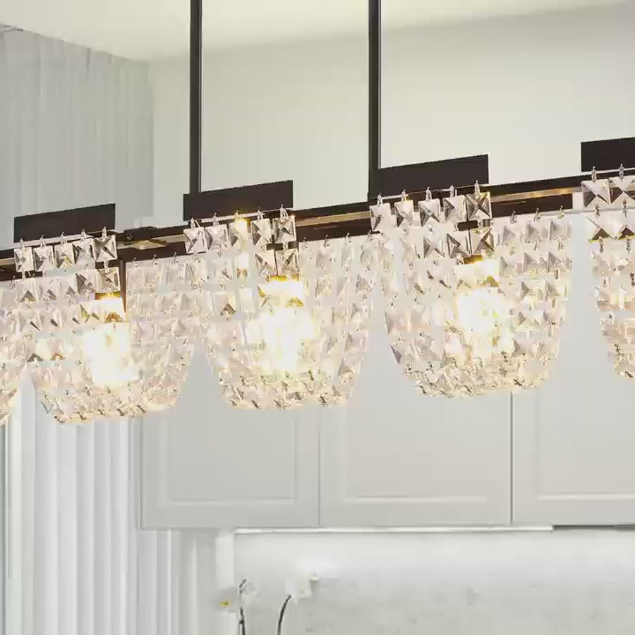 Linear chandelier filmed lit above a table