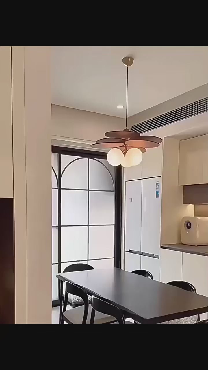 Walnut disc pendant light filmed lit