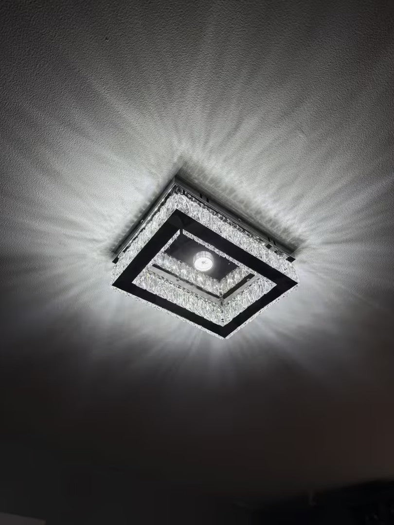 Rectangular crystal flush mount ceiling light casting a web of light at night Image