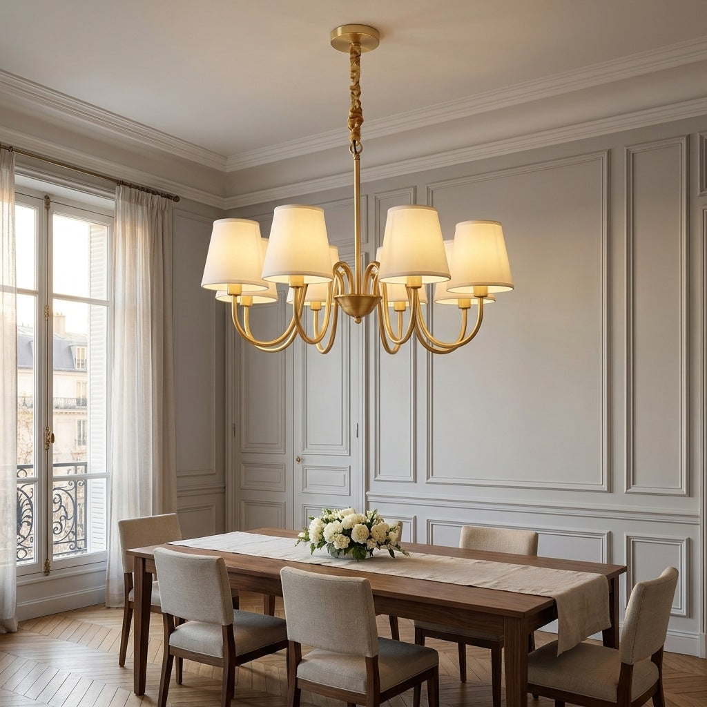 Vintage brass chandelier lit above a walnut table in a Haussmann dining room