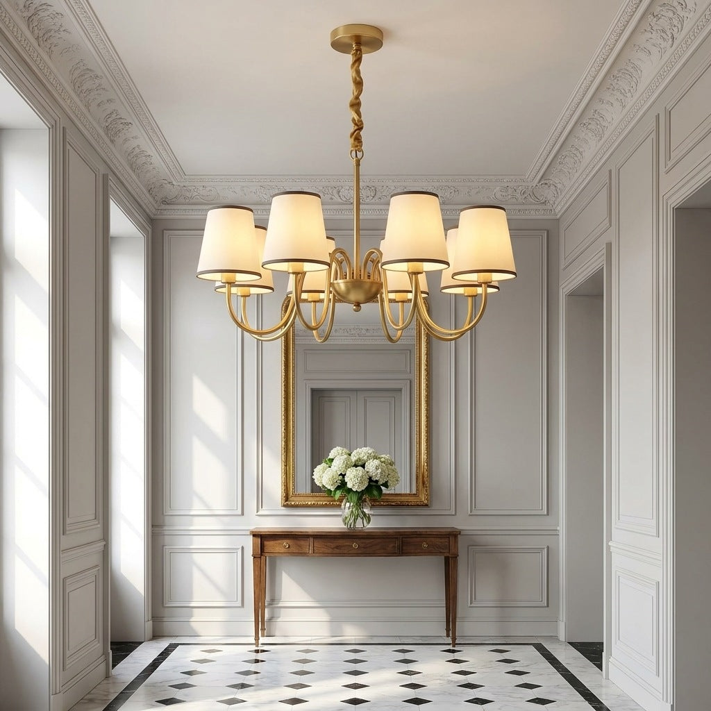 Vintage brass chandelier lit in a Haussmann entrance hall above a walnut console