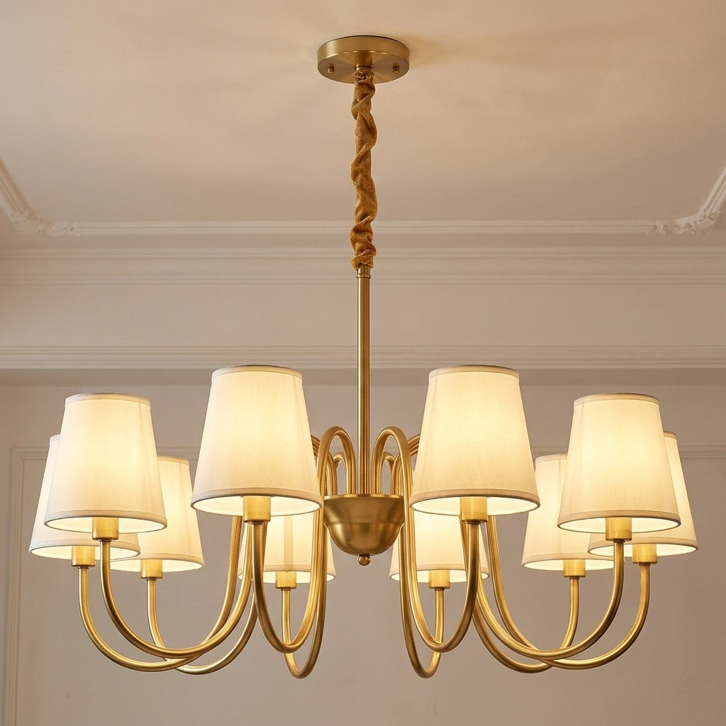 Vintage brass chandelier with 10 ivory fabric shades lit on a moulded ceiling, 34.6 inches across